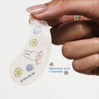 Miffy Calming Cloud Under Eye Patches — hand holding a translucent printed under-eye patch