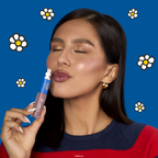 Miffy Glossy Lip Stain — model holding Miffy lip stain beside her face