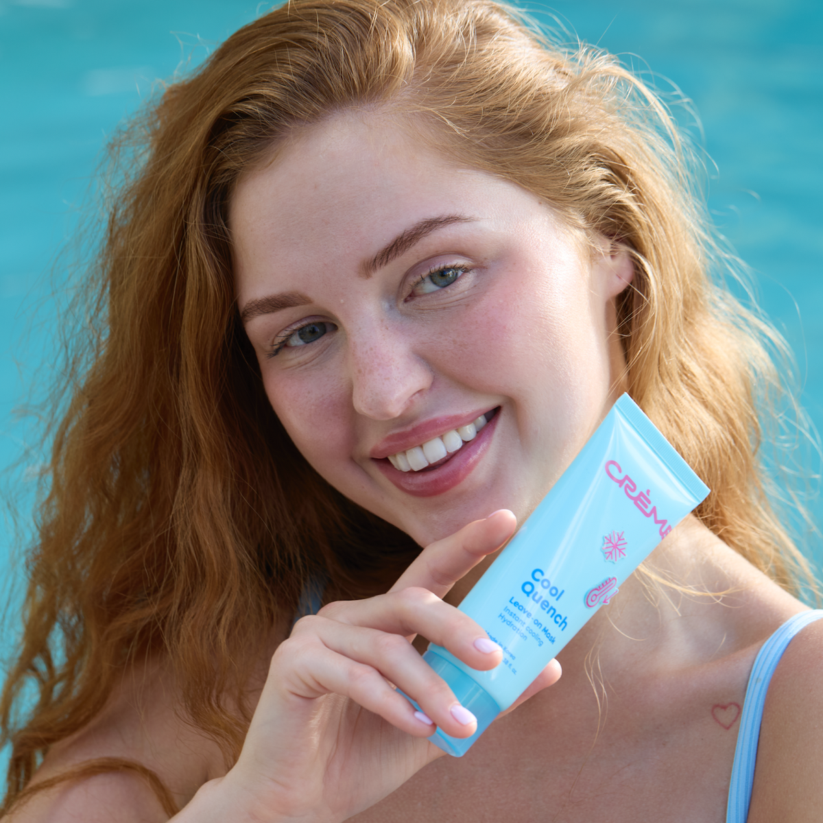 Cool Quench Leave On Mask — smiling model holding the tube beside her face