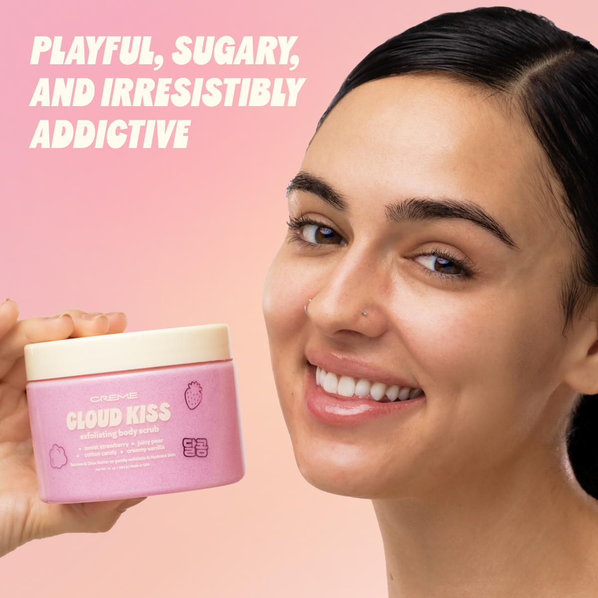 Cloud Kiss Exfoliating Body Scrub — model holding the jar beside her face