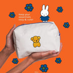 Miffy Perfect Travel Makeup Bag — hands holding the bag with yellow bear embroidery on the back